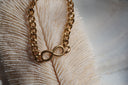 Gold-tone chain bracelet with an open infinity-shaped centrepiece.