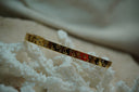 Alternate view: gold-tone narrow open cuff with crescent moons, stars and small clear round accents.