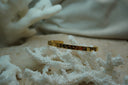 Gold-tone narrow open cuff with crescent moons, stars and small clear round accents.