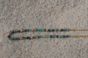 Detail view: necklace combining mottled green and grey beads with a gold-tone ball-chain section.