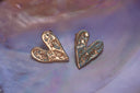 Alternate view: gold-tone asymmetric heart stud earrings with an irregular textured surface.