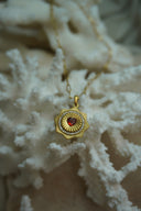 Alternate view: gold-tone long-link necklace with a radiating medallion, red heart centre and circular border of clear accents.