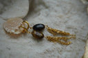 Alternate view: gold-tone hoop earrings with dark brown oval beads and hanging chain tassels.