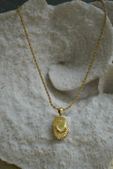 Alternate view: gold-tone necklace with a crescent moon and short rays on a rounded rectangular tile.