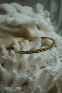 Alternate view: gold-tone bangle with alternating clear rectangular and round faceted accents.