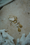 Alternate view: gold-tone hoop earrings with white rounded beads and sculpted teardrop-shaped charms.