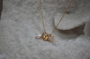Alternate view: gold-tone chain necklace with two fish charms, clear accents and a white oval bead.