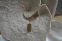 Alternate view: gold-tone necklace with a rectangular The Death pendant, coffin-and-cross illustration and XIII lettering.