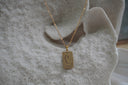 Gold-tone necklace with a rectangular The Death pendant, coffin-and-cross illustration and XIII lettering.