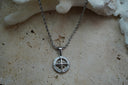 Alternate view: silver-tone twisted chain necklace with an open circular compass pendant, directional letters and scroll details.