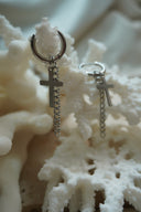 Alternate view: silver-tone hoop earrings with flat cross charms and longer hanging chain drops.
