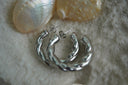 Alternate view: silver-tone open hoop earrings with two broad, smooth twisted strands.