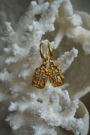 Alternate view: gold-tone hoops with textured rectangular charms and crosses formed from clear accents.