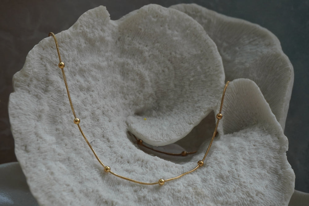 Alternate view: fine gold-tone necklace with evenly spaced round gold-tone beads.