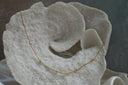 Fine gold-tone necklace with evenly spaced round gold-tone beads.