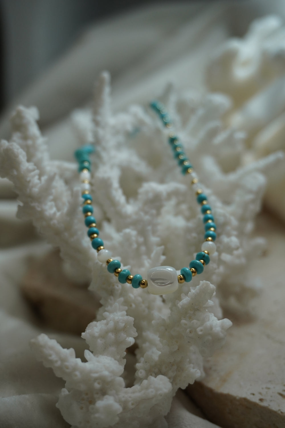Alternate view: necklace with blue disc-shaped beads, gold-tone spacers, white round beads and a rounded-square white centre bead.
