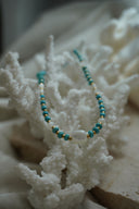 Alternate view: necklace with blue disc-shaped beads, gold-tone spacers, white round beads and a rounded-square white centre bead.