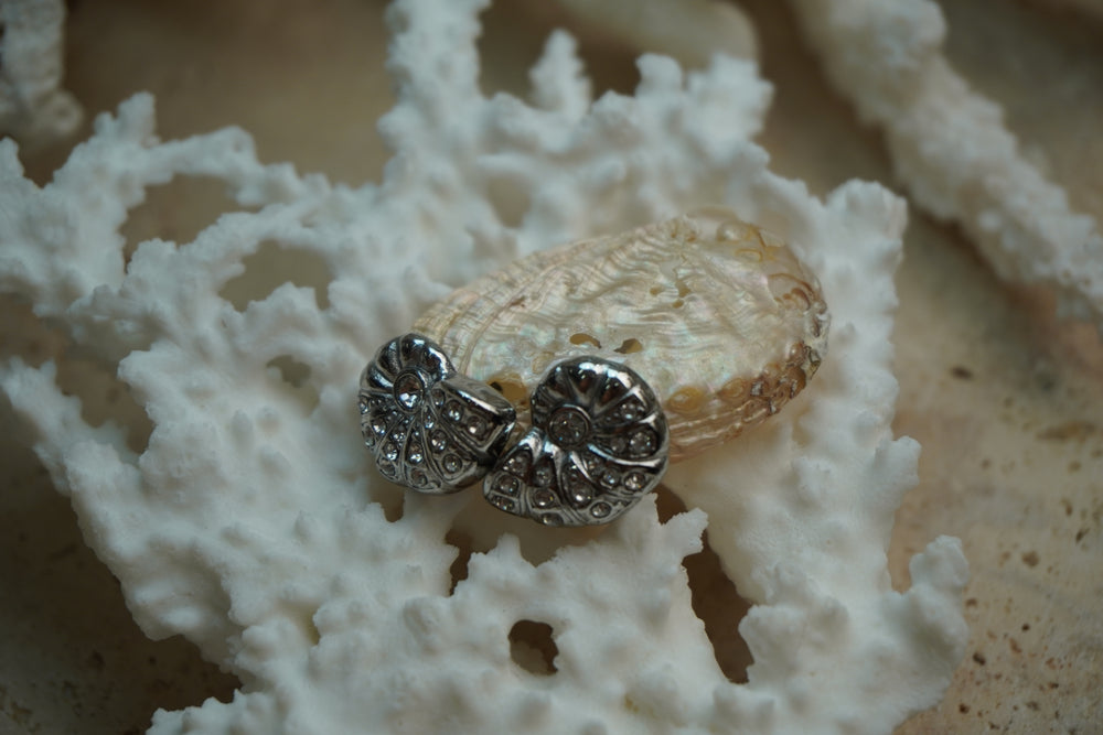 Alternate view: silver-tone spiral shell earrings with curved sections and small clear accents.