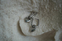 Silver-tone rounded rectangular hoops with small hanging heart charms.