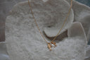 Alternate view: gold-tone necklace with a textured fish charm, clear-accent palm tree and white oval bead.