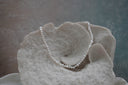 Alternate view: necklace of closely strung irregular white beads with an iridescent appearance.