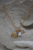 Gold-tone necklace with a ridged shell charm, radiating open heart and white heart bead with blue flowers.