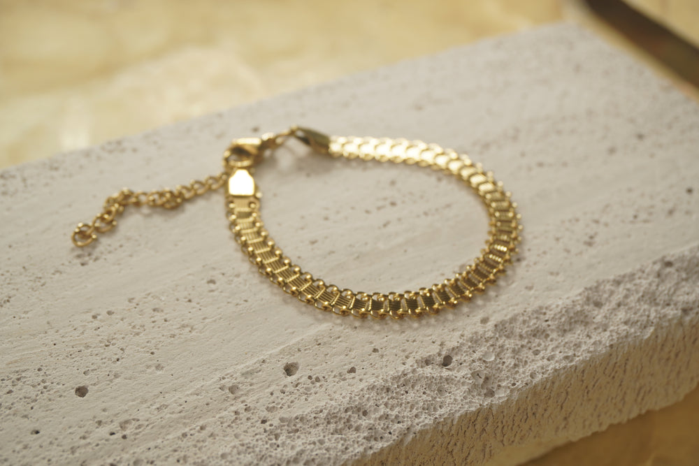 Alternate view: gold-tone bracelet with ridged rectangular panels, looped edges and an extension chain.