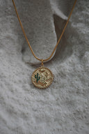 Alternate view: gold-tone disc necklace with a desert landscape, cactus motifs, green accents and a scalloped pendant edge.