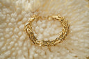 Alternate view: gold-tone bracelet with overlapping angular bar links, a clasp and extension chain.