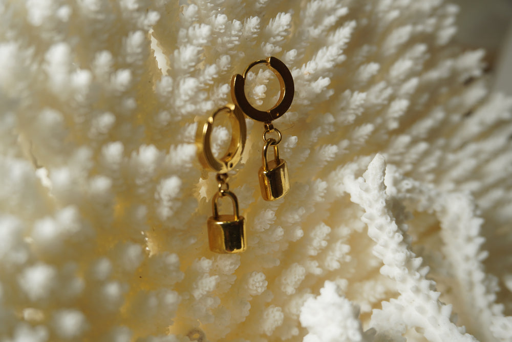 Alternate view: gold-tone hoop earrings with smooth rectangular padlock charms and curved lock tops.