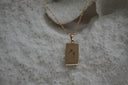 Gold-tone necklace with a rectangular Temperance pendant showing two goblets and XIV lettering.