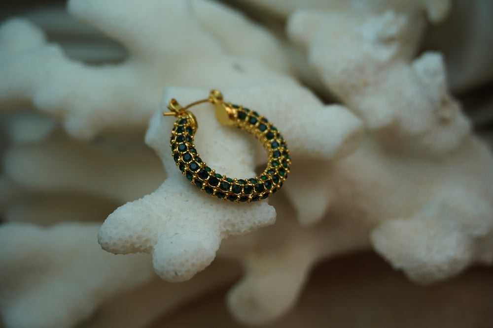 Alternate view: gold-tone hoop earrings covered in rows of dark green round accents.