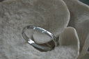 Silver-tone bangle with small star motifs and round clear accents.