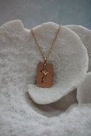 Alternate view: gold-tone chain necklace with a rectangular tag and a key charm with a star-shaped head.