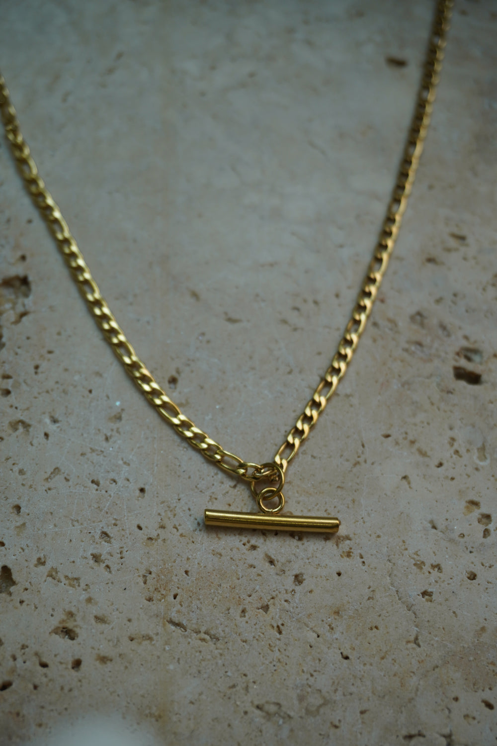 Alternate view: gold-tone necklace with alternating chain links and a smooth horizontal bar suspended at the centre.