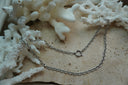 Alternate view: silver-tone layered chain necklace arrangement with oval links and a circular clasp detail on the upper line.