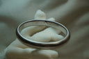 Silver-tone rounded bangle with closely spaced ribs around the band.