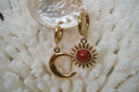 Alternate view: gold-tone hoop earrings with a red-centred sun charm and a smooth crescent moon charm.
