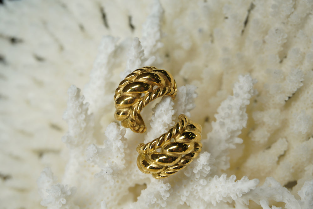 Alternate view: gold-tone broad open hoop earrings with diagonal central loops and twisted edge borders.