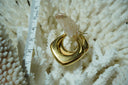 Gold-tone hoop earrings with rounded square outer corners and a curved open centre.