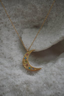 Alternate view: gold-tone crescent moon necklace with multicoloured round accents and scattered dimpled details.