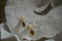 Alternate view: gold-tone hoop earrings with teardrop charms, round clear accents and sunburst markings.