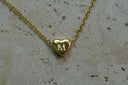 Alternate view: gold-tone fine chain necklace with a smooth heart centre bearing a raised M initial.