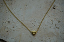 Gold-tone fine chain necklace with a smooth heart centre bearing a raised M initial.