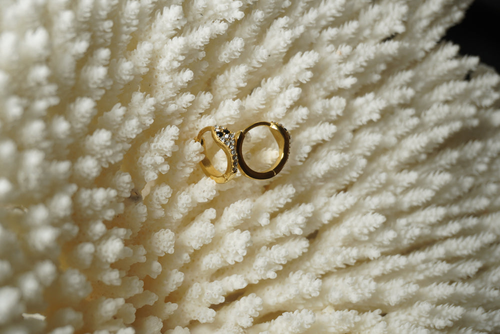 Alternate view: gold-tone snake-shaped hoop earrings with dark eyes and clear round accents.