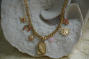 Alternate view: gold-tone necklace with sun, star, crescent and flower charms surrounding a textured moon-face plaque.