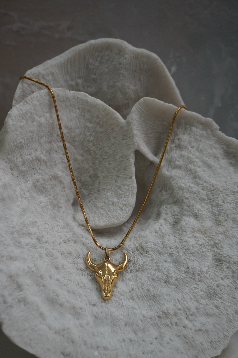 Alternate view: gold-tone necklace with a smooth bull-skull pendant, upward-curving horns and a close-linked chain.