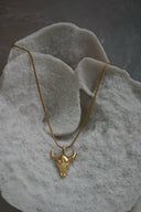 Alternate view: gold-tone necklace with a smooth bull-skull pendant, upward-curving horns and a close-linked chain.