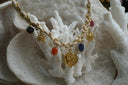 Alternate view: necklace with pale pink braided cord, gold-tone chain, multicoloured bead drops, sun charms and an eye-patterned disc.