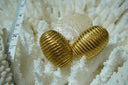 Gold-tone domed oval earrings with closely spaced parallel diagonal ridges.